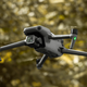 The DJI Mavic 3 Classic in flight in front of some thick foliage.